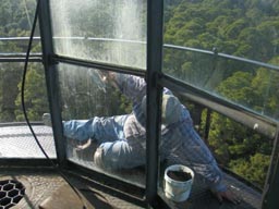 man paints lighthouse